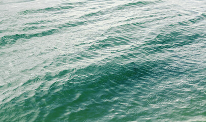 Blue water surface with waves. Sea waves. Water waves background. Clear water. Water texture.