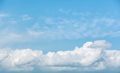 White clouds on blue sky. Clear sky with fluffy clouds. Beautiful cloudscape. Background with blue sky and white clouds.