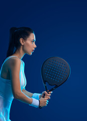 Padel tennis player with racket on tournament. Girl athlete with paddle racket on court at open tour. Neon colors. Sport concept. Download a high quality photo for design of a sports app. - 781511349