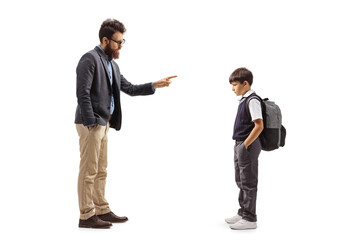 Full length profile shot of a father reprimanding a schoolboy
