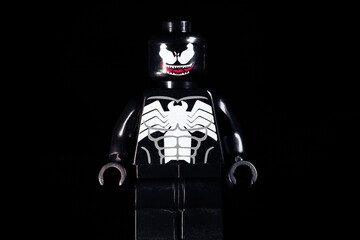 Fototapeta premium LEGO Marvel Venom with scary smile on a black background