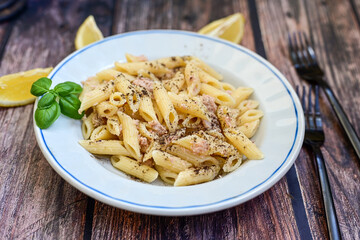  Italian home made  penne  pasta  with  tuna  fish, parmesan cheese and black pepper .