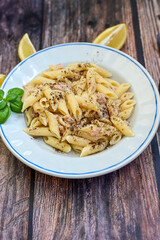  Italian home made  penne  pasta  with  tuna  fish, parmesan cheese and black pepper .
