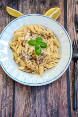  Italian home made  penne  pasta  with  tuna  fish, parmesan cheese and black pepper .
