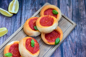 Mini margherita napoletan pizza with tomato,mozzarella  cheese and basil,  on wooden background