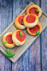 Mini margherita napoletan pizza with tomato,mozzarella  cheese and basil,  on wooden background