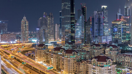 Fototapeta na wymiar Aerial view of illuminated skyscrapers and road junction in Dubai timelapse