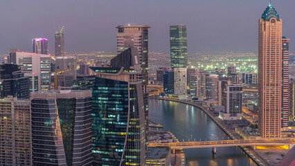 Aerial skyline of Dubai's business bay with skyscrapers day to night timelapse - obrazy, fototapety, plakaty