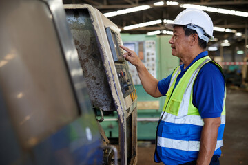 senior technician or engineer checking and control lathe machine in the factory