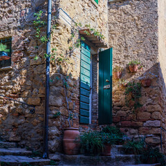 The old narrow streets in the medieval town of Casale Marissimo in Tuscany shot with analogue film technique - obrazy, fototapety, plakaty