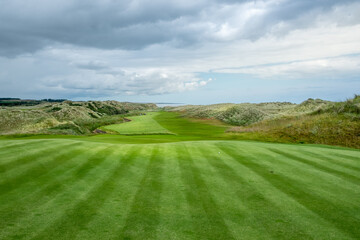 An hilly golf course facing the sea in Scotland - obrazy, fototapety, plakaty