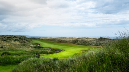 An hilly golf course facing the sea in Scotland