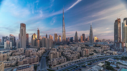 Dubai Downtown skyline timelapse with Burj Khalifa and other towers during sunrise panoramic view...