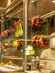 Roasted goose heads and necks hanging in a restaurant window in Hong Kong