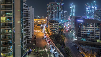 Dubai Marina skyscrapers and promenade aerial night timelapse, Dubai, United Arab Emirates
