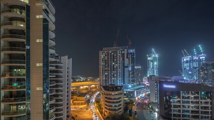 Dubai Marina skyscrapers and promenade aerial night timelapse, Dubai, United Arab Emirates