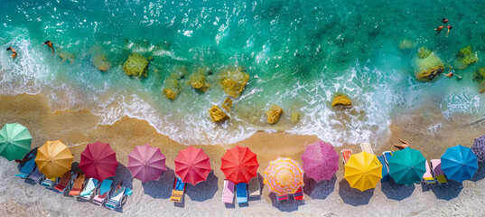 Aerial view of ocean shore with sun umbrellas, concept of summer holidays