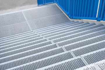 New staircase with perforated steps made from metal iron. Industrial background
