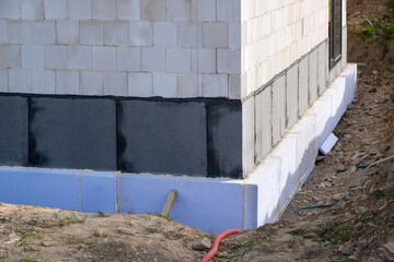 waterproof thermal insulation coatings on the Foundation of the bottom wall in a new private house...