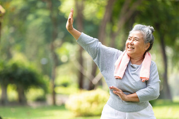asian senior woman workout and practice tai chi in the park