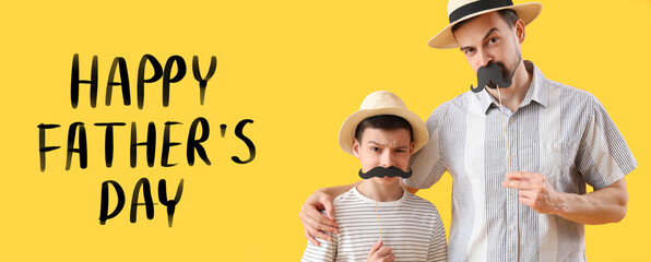 Portrait of funny father and his little son with paper mustache on yellow background - obrazy, fototapety, plakaty