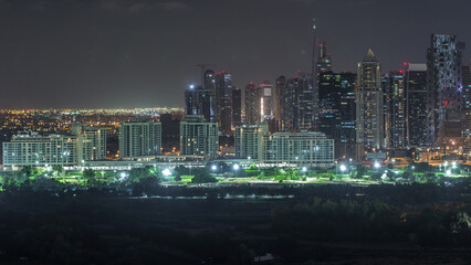 Jumeirah lake towers skyscrapers and golf course night timelapse, Dubai, United Arab Emirates