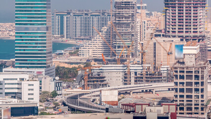 Dubai media city skyscrapers and construction site on palm jumeirah timelapse, Dubai, United Arab...
