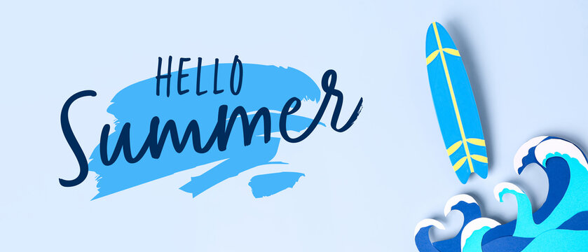 Creative composition with paper waves and mini surfboard on blue background