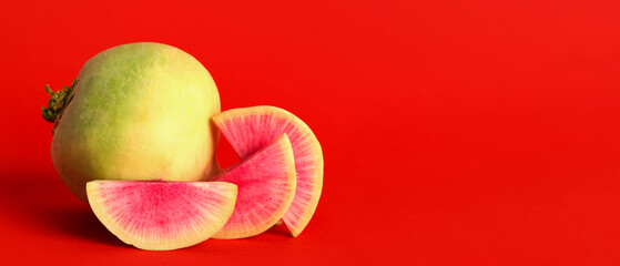 Ripe watermelon radish on red background