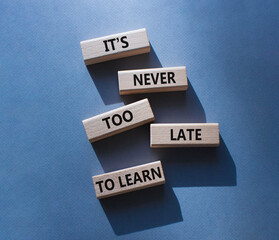 It is Never to Late to Learn symbol. Wooden blocks with words It is Never to Late to Learn. Beautiful grey background. Business and It is Never to Late to Learn. Copy space.