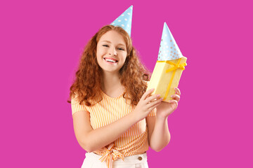 Happy beautiful woman with Birthday gift on purple background