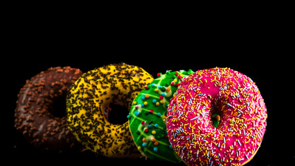  Glazed donuts with sprinkles isolated. Close up of colorful donuts.