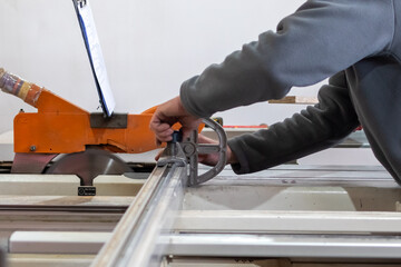 Furniture manufacture. Cutting wood panels on circular saw in production of cabinet furniture