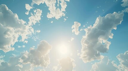A serene sky, filled with fluffy white clouds against a vibrant blue backdrop