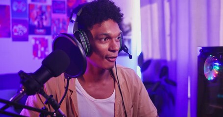 Man, gamer streaming online and headphones with microphone, esports competition or tournament at home. Neon light, content creation and pro gaming for social media with internet for followers