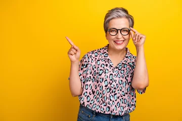 Foto op Plexiglas Photo portrait of pretty retired female point empty space poster dressed stylish leopard print outfit isolated on yellow color background © deagreez