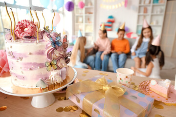 Birthday cake on table at children's party, closeup
