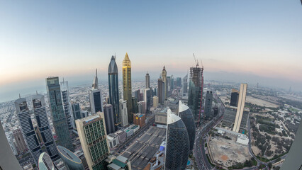 Skyline of the buildings of Sheikh Zayed Road and DIFC aerial day to night timelapse in Dubai, UAE.