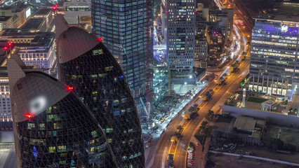 Skyline of the buildings of Sheikh Zayed Road and DIFC aerial night timelapse in Dubai, UAE.