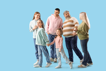 Big family holding hands on blue background