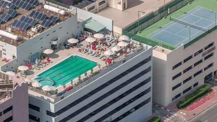Car parking lot with rooftop swimming pool viewed from above timelapse, Aerial top view. Dubai, UAE © HyperlapsePro