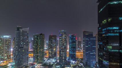 Residential and office buildings in Jumeirah lake towers district night timelapse in Dubai