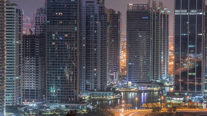 Fototapeta na wymiar Residential and office buildings in Jumeirah lake towers district night to day timelapse in Dubai