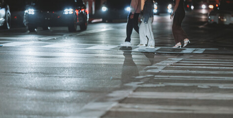 people walking on the street night cars traffic 