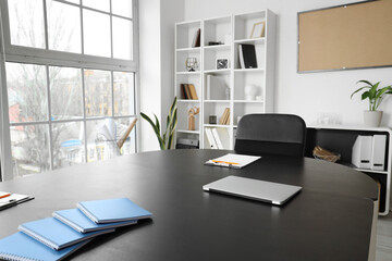 Table with clipboard and laptop in office prepared for meeting