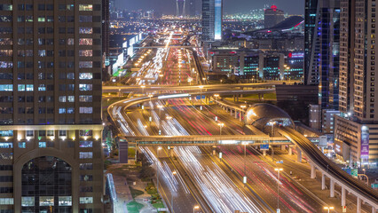 Skyline internet city with crossing Sheikh Zayed Road aerial night timelapse