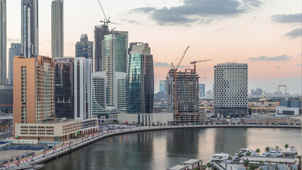 Fototapeta na wymiar Dubai skyscrapers after sunset near river aerial day to night timelapse