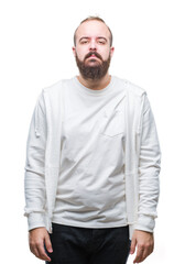 Fototapeta premium Young caucasian hipster man wearing sport clothes over isolated background with serious expression on face. Simple and natural looking at the camera.