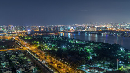 Fototapeta na wymiar Nighttime rhythm of the city of Dubai near canal aerial timelapse