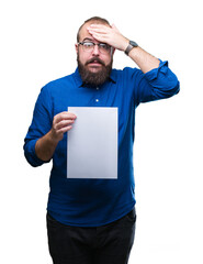 Young hipster man wearing glasses and holding blank paper over isolated background stressed with hand on head, shocked with shame and surprise face, angry and frustrated. Fear and upset for mistake.